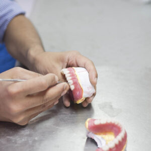 Dental technician working on impression and creating outstanding dental care